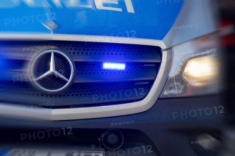 Symbolic image police operation: close-up of a blue light on a police car (digitally reworked)