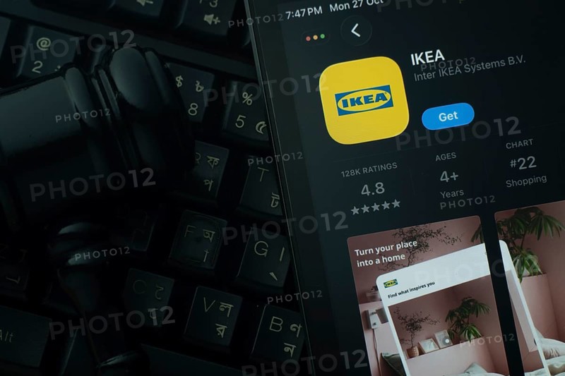 Dhaka, Bangladesh- 28 Oct 2025: An iPad displaying the IKEA app against a judge's gavel and dark keyboard background