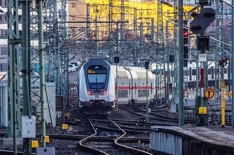 InterCity IC to Zurich leaving Stuttgart Central Station in the morning. Rail signals and overhead lines in early morning light. Stuttgart, Baden-Württemberg, Germany