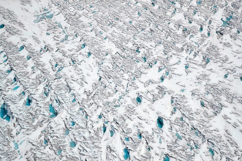 Aerial view of meltwater on the Greenland ice sheet, Arctic landscape, frozen wilderness, glaciers and snow-covered terrain, Climate change, Global warming, Greenland, North America