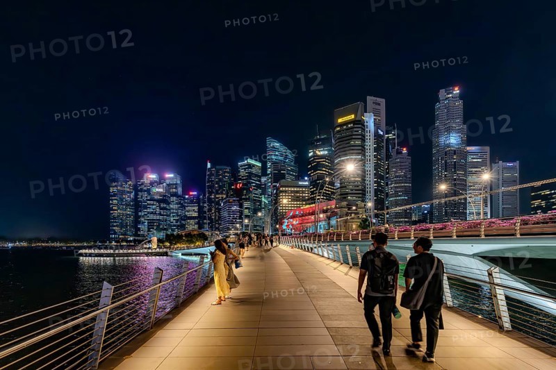 Skyline of the Central Business District, CBD with illuminated skyscrapers and Jubilee Bridge in the city Singapore at night, Southeast Asia