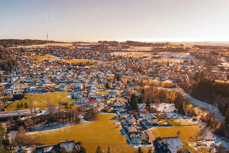 Aerial view of a sprawling settlement in winter with snowy fields and soft light, Hallwangen, Freudenstadt district, Germany