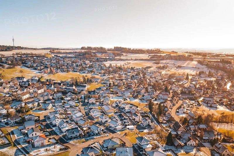 Bird's-eye view of rural winter landscape with snow-covered houses and fields, Hallwangen, Freudenstadt district, Germany