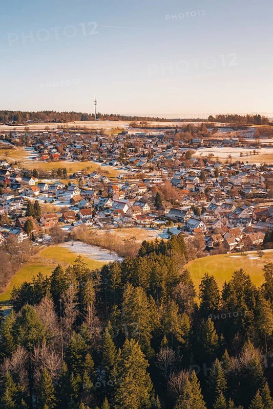 Snow-covered landscape with village and adjacent forest in a wintry atmosphere, Hallwangen, Freudenstadt district, Germany