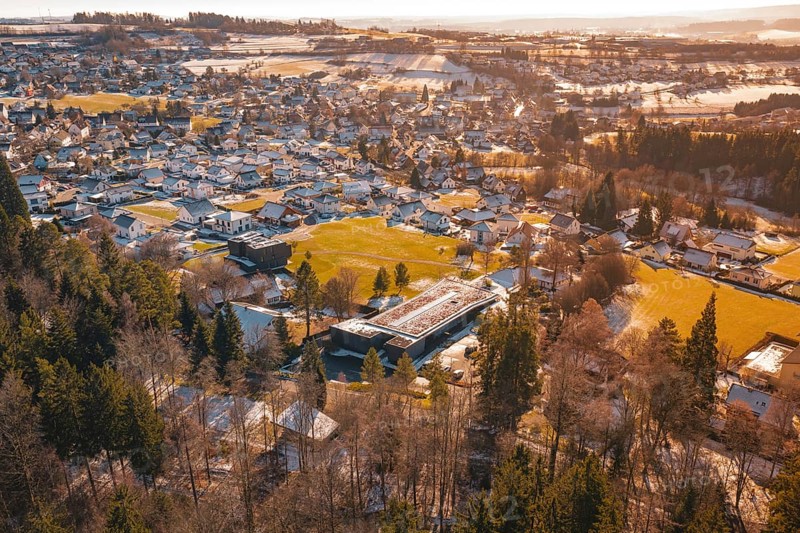 Winter landscape of a small town with snow-covered roofs and surrounding fields, Hallwangen, Freudenstadt district, Germany
