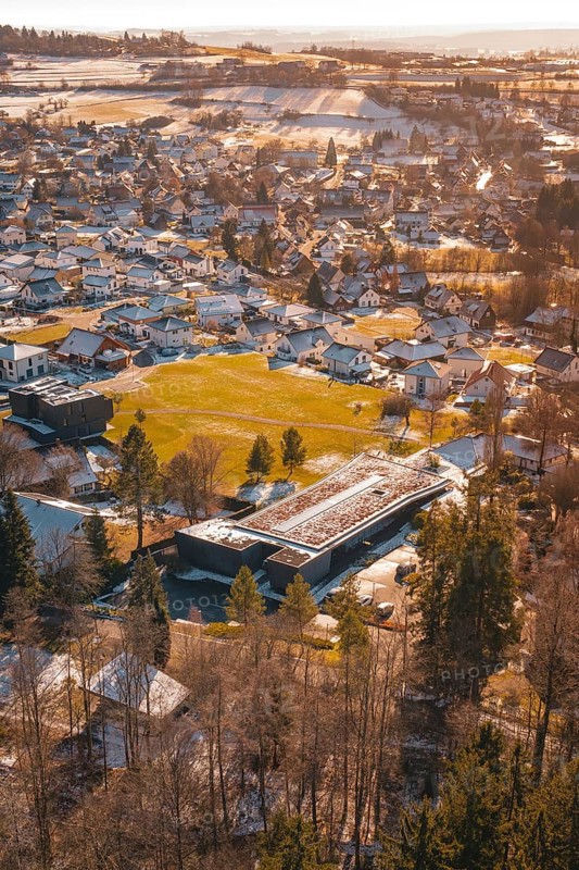 Small town with snow-covered roofs and trees from a bird's eye view, Hallwangen, Freudenstadt district, Germany