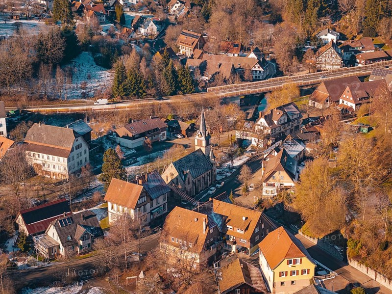 Village in winter with a distinctive church and surrounding snow-covered houses, Aach, Dornstetten, Freudenstadt district, Germany