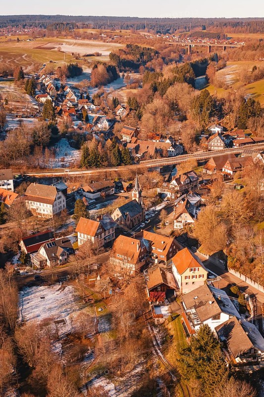 Church in the middle of a snowy village against a forest backdrop, Aach, Dornstetten, Freudenstadt district, Germany
