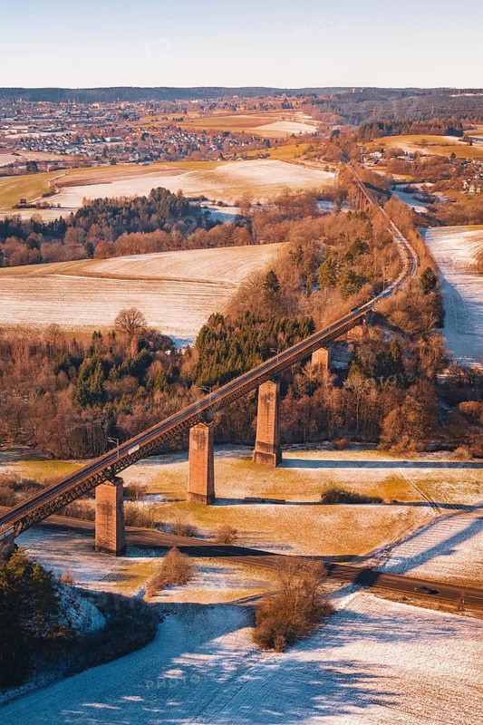Railway bridge in winter surrounded by snow-covered fields and roads, Dornstetten, Freudenstadt district, Germany