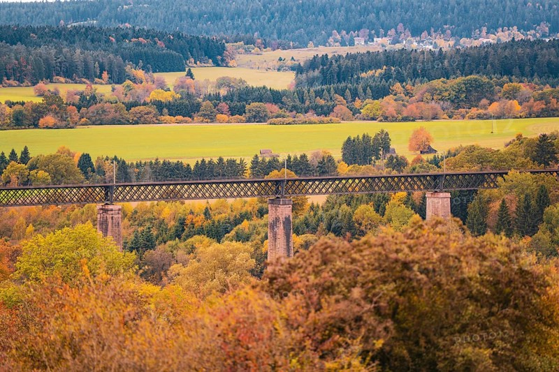 Bridge over an autumn landscape with colorful trees and meadows, Dornstetten, Freudenstadt district, Germany