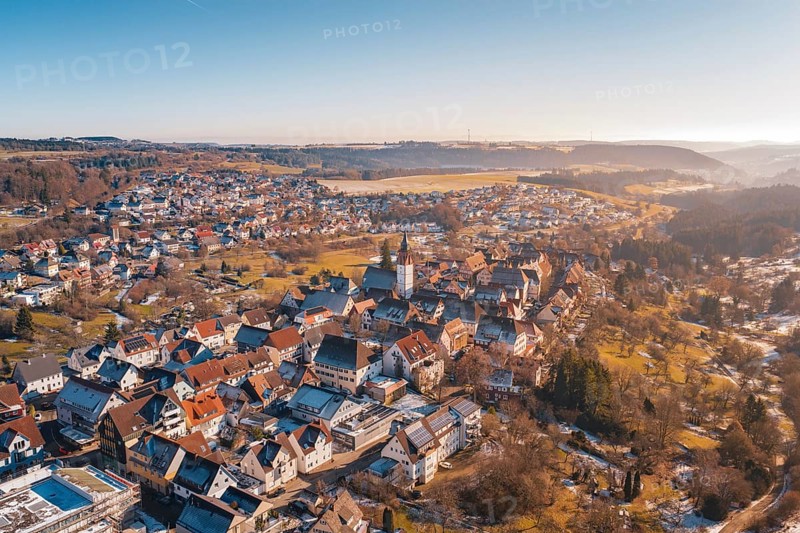 Impressive aerial view of a town with a central church, wide valley in sunlight, Dornstetten, Freudenstadt district, Germany