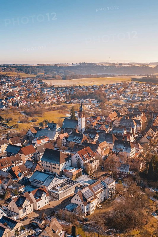 City view from the air with church architecture, surrounded by red roofs, in a winter landscape, Dornstetten, Freudenstadt district, Germany