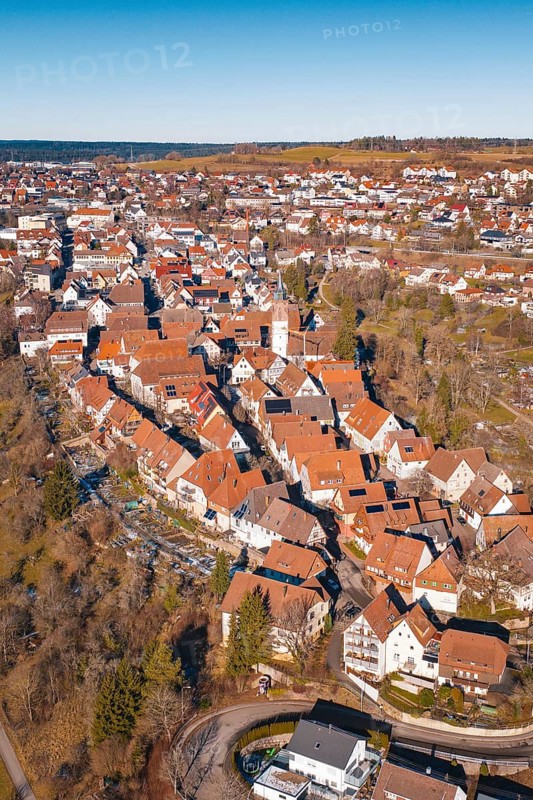 Aerial view of dense buildings with red roof tiles in a wintry environment, Dornstetten, Freudenstadt district, Germany