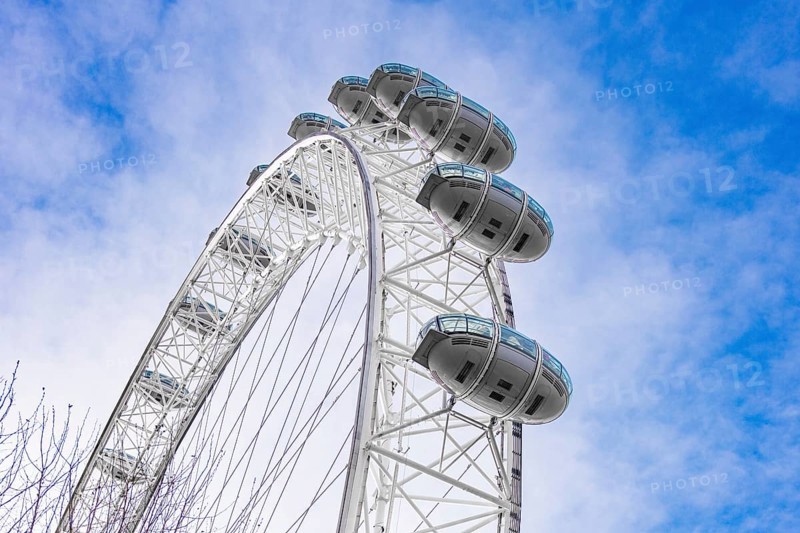 View of a Ferris wheel with white cabins against a blue sky, London Eye, London, United Kingdom