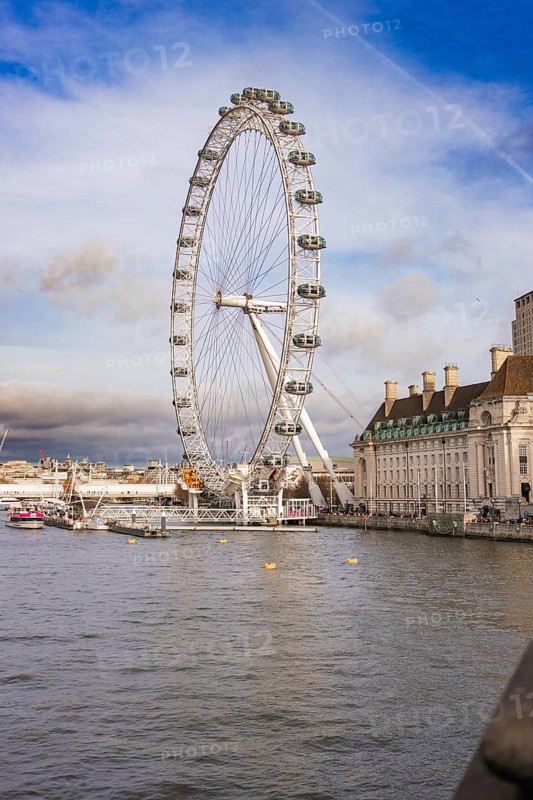 City panorama with a Ferris wheel on a river under clear sky, London Eye, London, United Kingdom