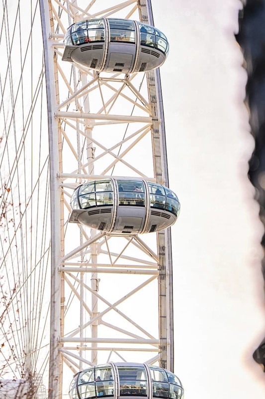 Close-up of a Ferris wheel with futuristic cabins against a bright sky, London Eye, London, United Kingdom