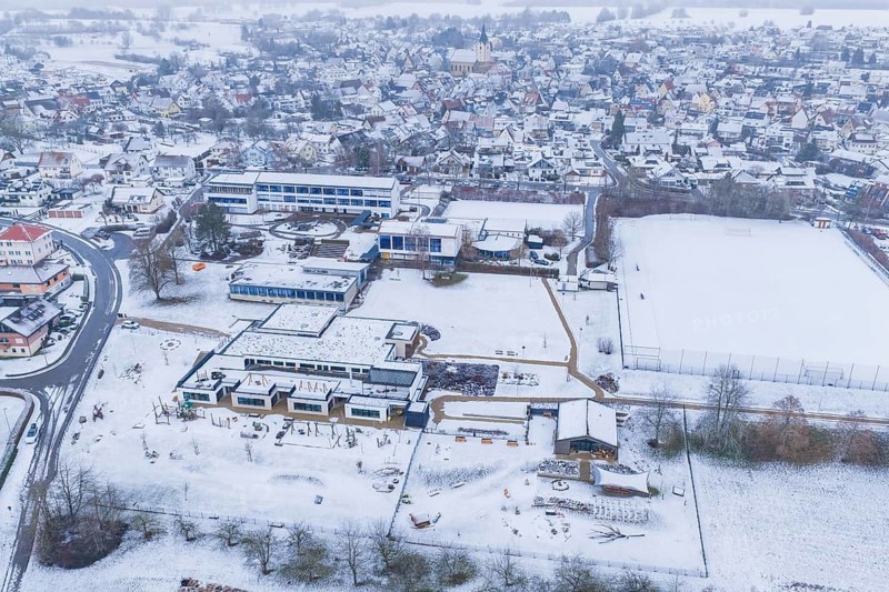 Modern and traditional buildings in a snowy village with streets and squares, Empfingen, Freudenstadt district, Germany