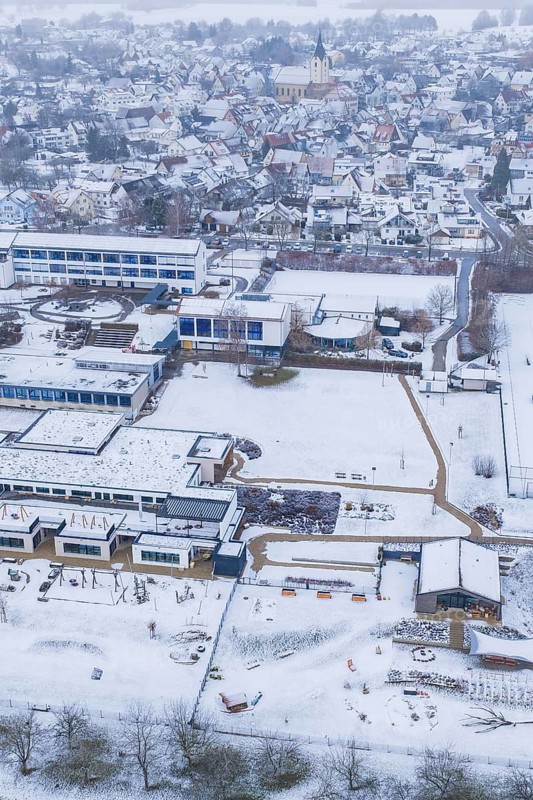 Aerial view of a sprawling village with snowy roofs and roads, Empfingen, Freudenstadt district, Germany