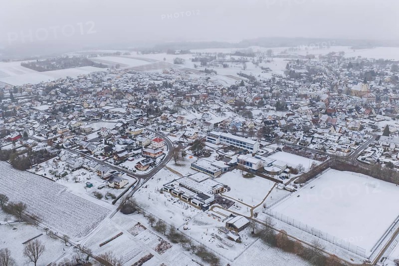 Snowy village with wide fields, houses and roads from a bird's eye view, Empfingen, Freudenstadt district, Germany