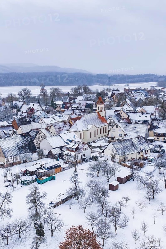 Village in winter with snow-covered houses and a church, cold atmosphere, Wiesenstetten, Freudenstadt district, Germany
