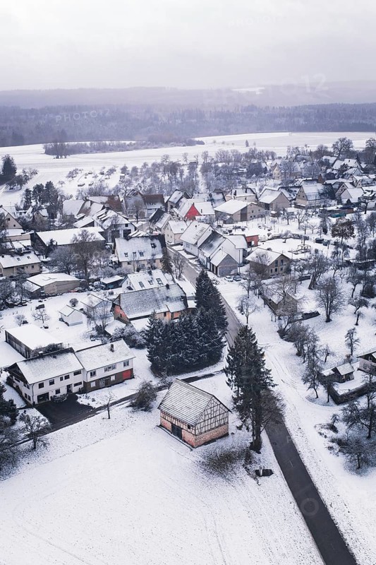 Wintery village with snow-covered houses and trees, cold landscape atmosphere, Wiesenstetten, Freudenstadt district, Germany