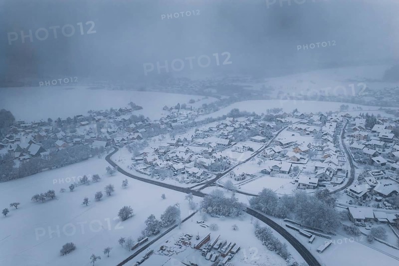 Snowy landscape with villages and fields under a foggy winter sky, Hörschweiler, Freudenstadt district, Germany