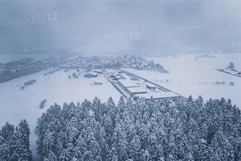 Aerial view of a snowy village surrounded by forests, Hörschweiler, Freudenstadt district, Germany