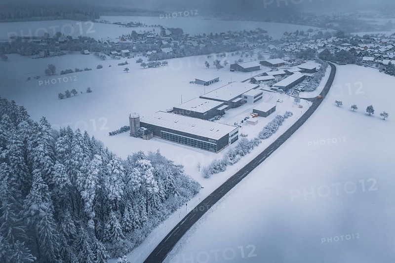 Snowy landscape with forest, surrounding villages and a factory in the foreground, Hörschweiler, Freudenstadt district, Germany