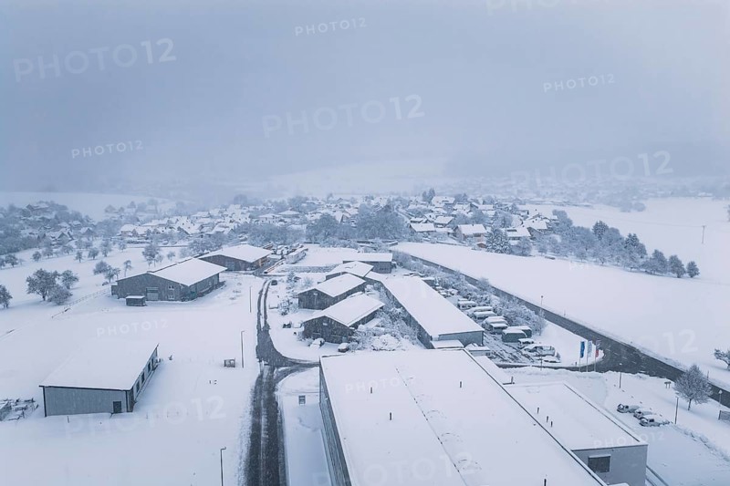 Snow-covered buildings and roads in a quiet village, Hörschweiler, Freudenstadt district, Germany