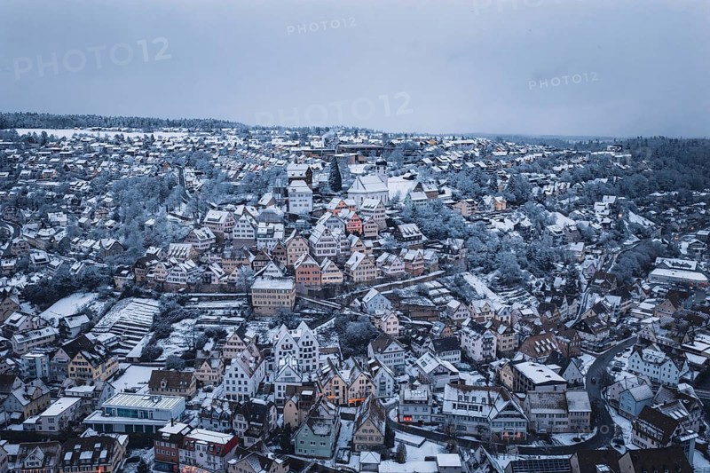 Panoramic view of a snowy town with densely packed houses and trees, Altensteig, Calw district, Germany