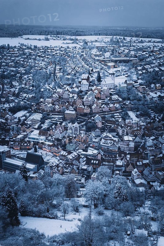 Far-reaching view of a snowy urban landscape with church and houses, Altensteig, Calw district, Germany