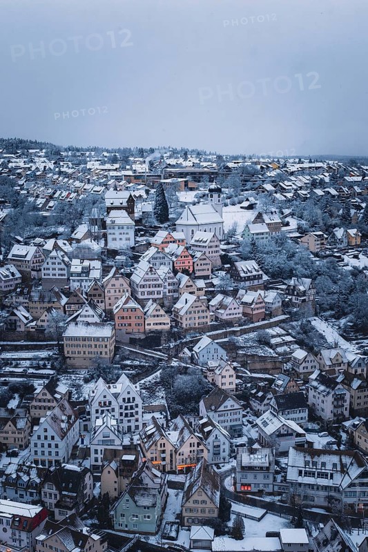 Snowy town with half-timbered houses and church, surrounded by winter landscape, Altensteig, Calw district, Germany