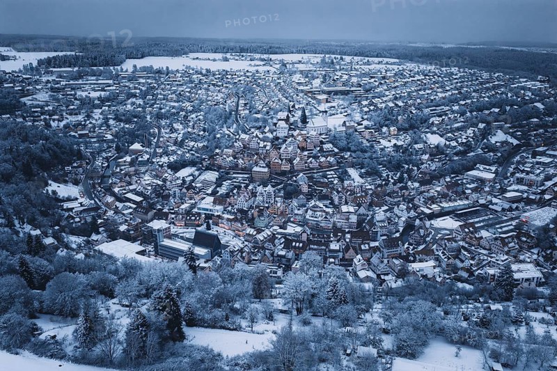 Extensive snow-covered urban area with forests and dense residential areas, Altensteig, Calw district, Germany