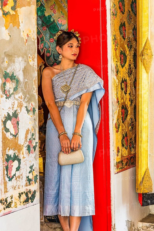 Young woman in traditional clothing presents herself to photographers, Wat Arun Buddhist temple, Bangkok, Thailand's metropolis, Thailand
