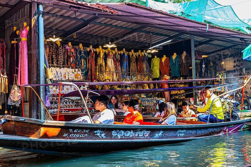 Wooden boat with tourists on the Damneon Saduak floating markets channel, near Bangkok, Ratchaburi district, Thailand