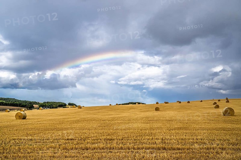 Rainbow over Straw bales, Scottish fields, Southeast Scotland, UK