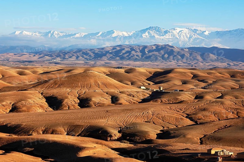 Agafay desert, rocky desert, snow-covered Atlas Mountains behind, near Marrakesh, Morocco