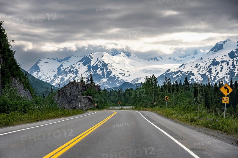 Road through mountain landscape, picturesque landscape with Worthington glacier, dramatic cloudy sky, Richardson Highway, Alaska, USA