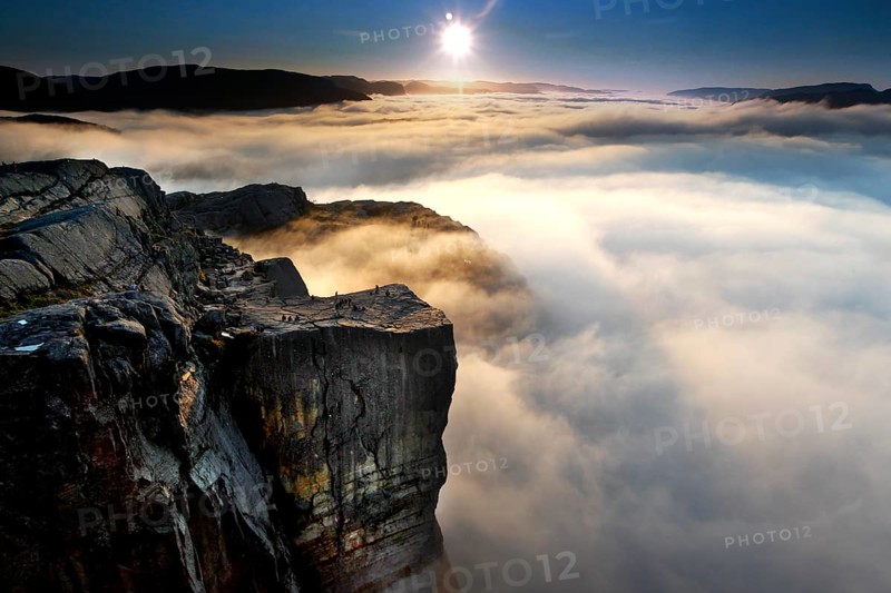 Prekestolen in morning light at sunrise with clouds and golden light