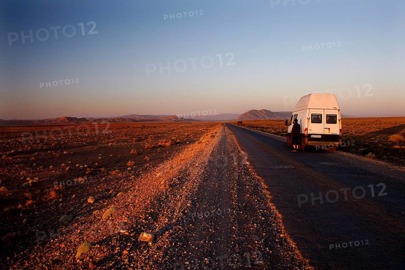 Transporter on lonely road in breathtaking evening scenery, Gourrama, Morocco
