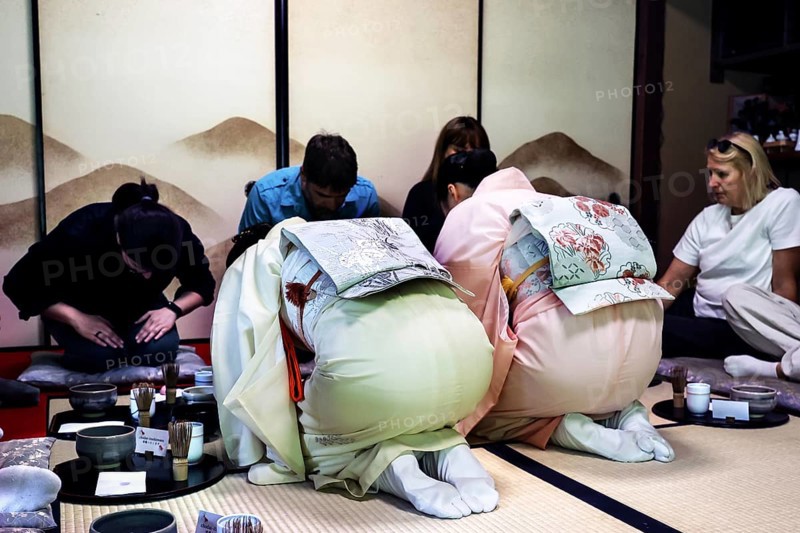 Attendees bow during the tea ceremony in a traditional room, Kyoto, Higashiyama, Japan