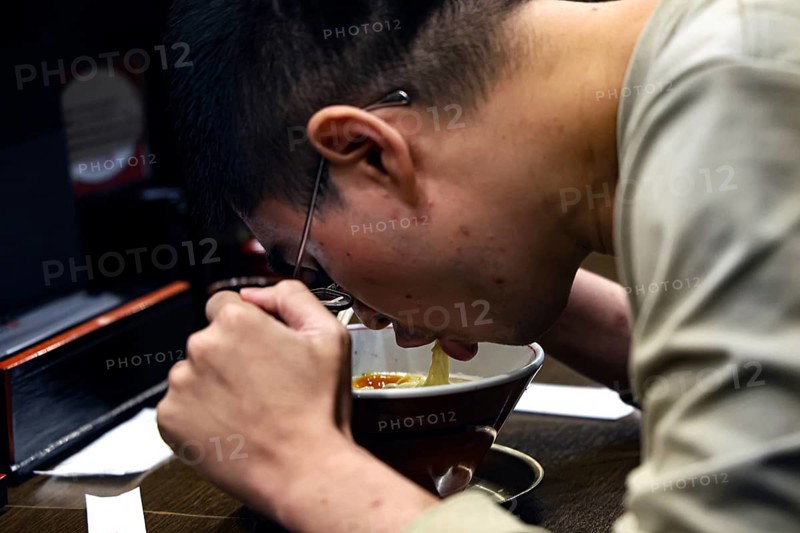 Guest at Ramen Restaurant in Higashiyama devotedly enjoys his meal, Kyoto, Higashiyama, Japan