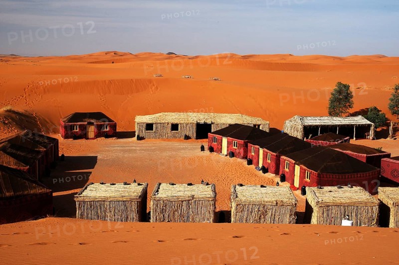 Desert camp in Erg Chebbi with tents and huts in a sandy desert landscape, Erg Chebbi, Morocco