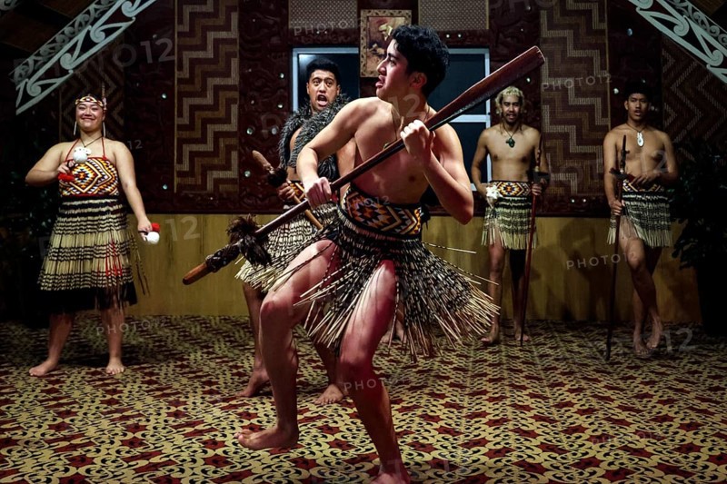 Maori warrior dancing with a spear in a tribal house, Rotorua, Te Puia, New Zealand