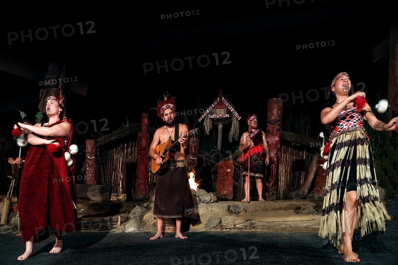 Group of Maori wearing traditional dress at a dance performance on stage in Rotorua, Rotorua, Bay of Plenty, New Zealand