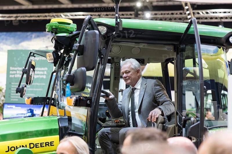 Alios Rainer (Federal Minister of Agriculture, Food and Home Affairs) sits in an electric John Deere E-Power prototype tractor during the opening tour of the Green Week at the exhibition grounds in Berlin on 16 January 2026. The trade fair for the agricultural and food industry will take place from 16-25 January 2026