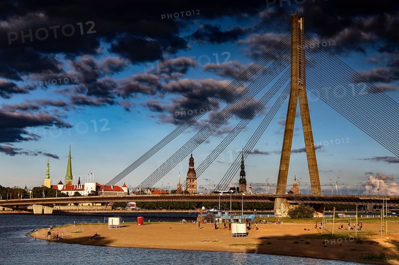 Beach on the Düna with a view of the Vansu Bridge and skyline of Riga, Riga, Vidzeme, Latvia