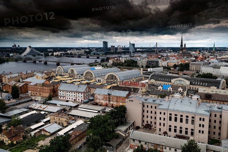 Dramatic city panorama of Riga with clouds above the Central Market, Riga, Latvia, Latvia