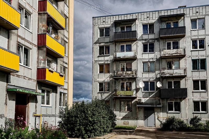 Two-tone prefabricated building with colorful balconies and clouds in the sky, Liepaja, Karosta, Latvia