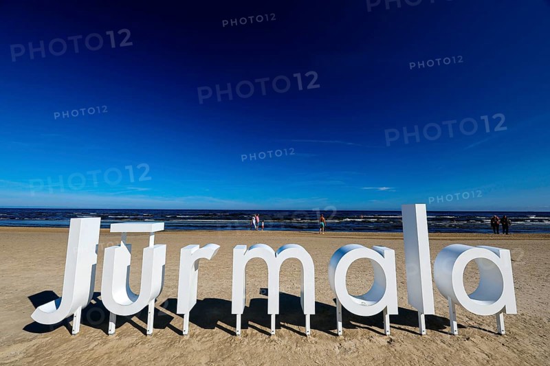 Large Jurmala logo on extensive beach under clear blue sky, Majori, Jurmala, Latvia